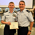  An EMS ISD cadet poses with his distinguished certificate from JROTC Leadership Camp. 